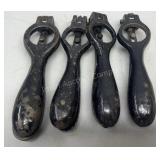 Four antique shell priming tools
