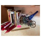 Cookbooks, candles and wine bottle