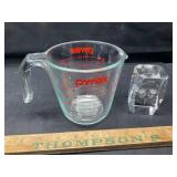 Pyrex measuring cup and paper weight