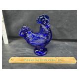 Cobalt blue hen on a nest