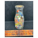 Milk bottle with marbles