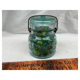 Vintage blue jar with marbles