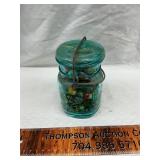 Blue jar with marbles