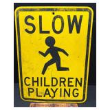 Slow children playing road sign