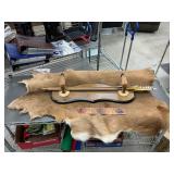 Hide with gun rack and arrows