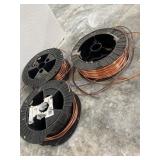 Spools of Copper Wire on Black Plastic Reels