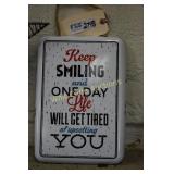 Keep smiling tin sign approximately 12"x9"