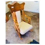 ornate rocking chair with padded seat