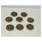 8 brass coasters with 'S' embossed