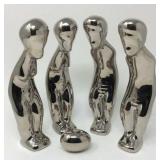 Mid-century modern alien figurines observing egg