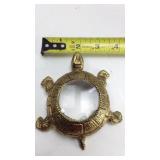 Golden turtle newpaper magnifying glass