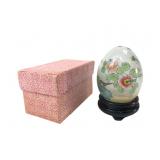 Vintage reverse painted glass egg on wooden stand