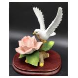 Porcelain dove on a rose
