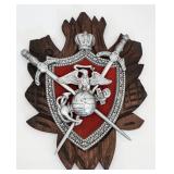 Metal shield on wooden wall plaque