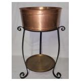 Copper tone tub on iron stand