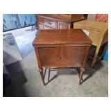 vintage sewing machine in cabinet