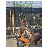 pile of brooms, squeegee, dust pans
