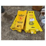 pile of wet floor signs
