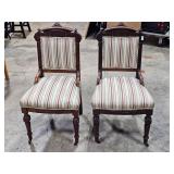 2 vintage chairs with wheels on front legs