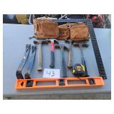 hammers, belt, square, bars, tape, etc.