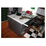 Desk, typewriter, pens, and other office supplies