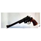 SMITH AND WESSON MD. 27-2 REVOLVER - 357 MAGNUM – 8 3/8” BBL – SMITH AND WESSON CHECKERED GRIPS – SMALL FINISH RUB ON BOTTOM OF GRIP - RECEIVER BLUING DEEP COLOR – VERY MINOR SCRATCH NEAR GR