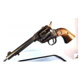 RUGER SINGLE SIX REVOLVER – 22 CAL SINGLE ACTION – BROWN RUGER GRIPS – CORNER OF WALNUT GRIP LEFT SIDE SPLIT – SHOWS CARRY AND USE WEAR – BLUING GOOD AND SMOOTH – SMALL CIRCLE ON BBL – S