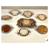 BELT BUCKLE W/ SILVER DOLLAR HOLDER - (7) SILVER DOLLAR HOLDERS - (2) LEATHER BELTS THAT HOLDERS HAVE BEEN ATTACHED TO
