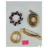 GOLD COLORED NECKLACE- W/ CAMEO STYLE PENDANT- YELLOW GOLD COLORED BROACH- VINTAGE GOLD TONE BROACH W/ ENTWIND CIRCLE DESIGN- VINTAGE PURPLE PRONG SET RHINESTONE BROACH- BLACK CASE
