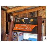VINTAGE WEAKLEY COUNTY AMUSEMENT ADVERTISEMENT SIGN - HAND PAINTED - 19 TN ORANGE COLOR  - FLAG MOUNT ON SIDE - 27" WIDE X 17" DEEP X POST 6 FT. TALL - PAINTED BROWN