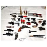 32+/- GUN & AMMO CIGARETTE LIGHTERS- SHOTGUNS, HANDGUNS,DERRINGER, TACTICALS, REVOLVERS, SMALL CANON, GERENADES, HATCHET- OTHER MISC