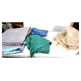 GREEN TARP- BLUE TABLECLOTH- LIGHT BLUE BLANKET- GRAY EQUIPMENT COVER