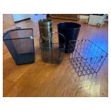Metal and brass trash cans in baskets