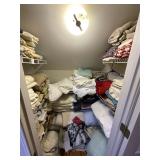 Closet, full of linens, pillows, sheets, etc.