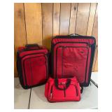 Three ï¿½ piece red luggage set