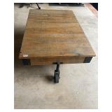 Wood and steel wheel rolling coffee table