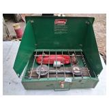 Coleman model 425E camp stove - has dent