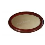 Oval Wooden Framed Mirror w a Decorative Border.