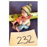 Hummel boy sitting blowing a horn