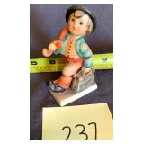 Hummel boy with umberella and suitcase