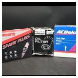 Assortment of Automotive Parts: Spark Plugs &...