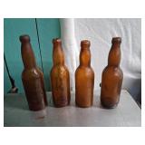 Four Embossed Amber Bottles