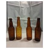 Four Amber Glass Bottles