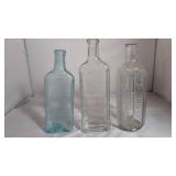 Three Embossed Glass Bottles