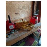 Two Red Gas Cans and Yellow Extension Cord