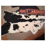 Cowhide Rug and Bear Creek Lodge Sign