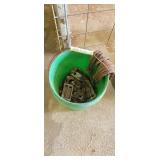 Green bucket full of assorted hardware