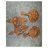 Four Griswold Cast Iron Trivets Assorted Styles