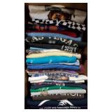 Box of various graphic t-shirts