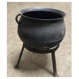 Vintage cast iron cauldron on stand